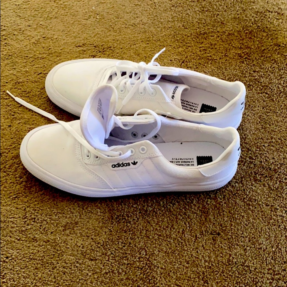 All white Adidas skate shoes